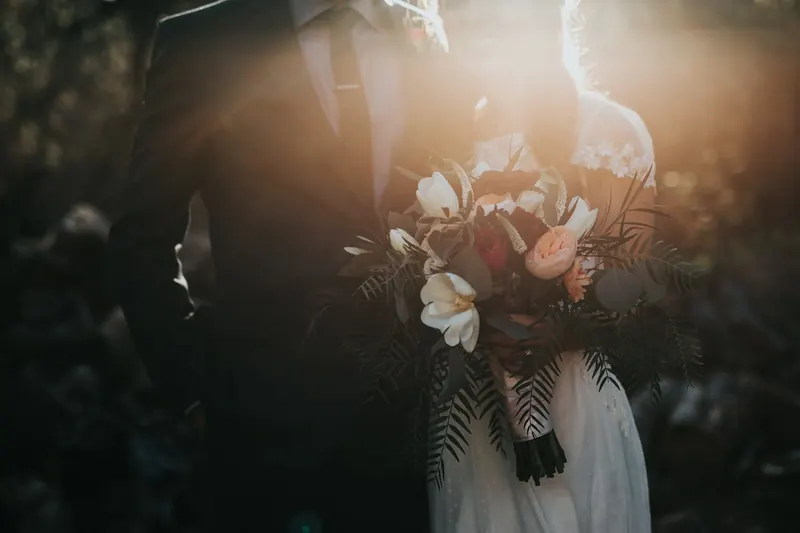 A bride holding her bouquet in warm golden light