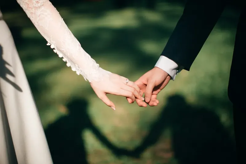 A couple holding hands in the sunlight